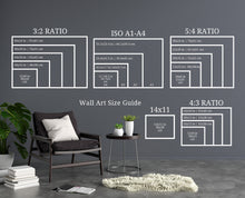 Load image into Gallery viewer, a room with a chair and a table with a plant on it
