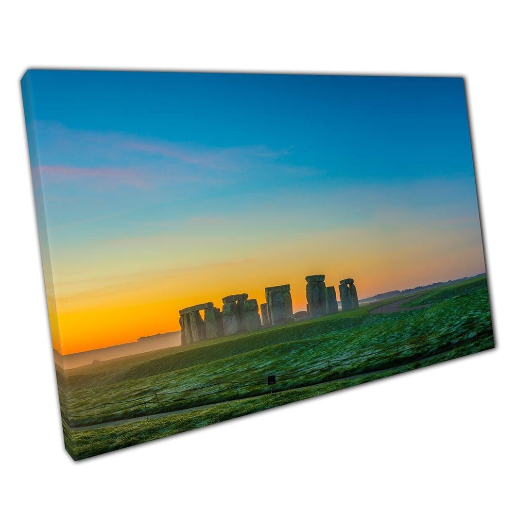 Stonehenge In Winter Surrounded By A Light Morning Mist Under A Vibrant Sunrise Wall Art Print On Canvas Mounted Canvas print
